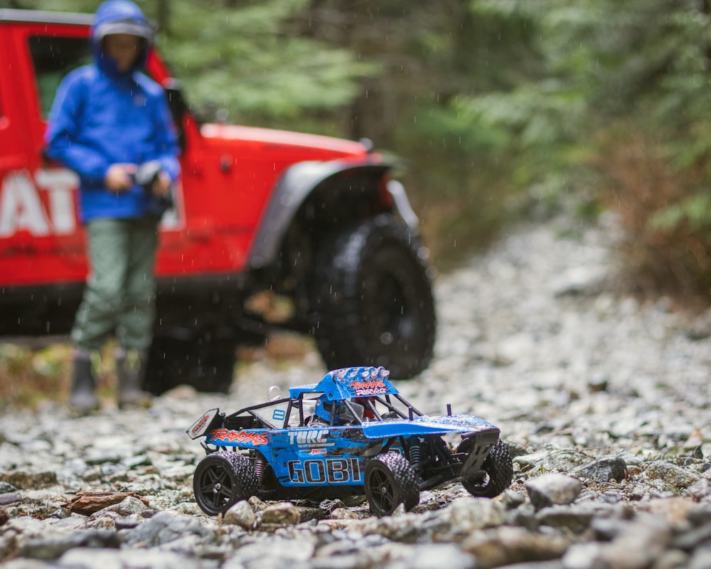 blue and black toy car on rocks