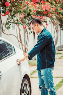 man opening white car door