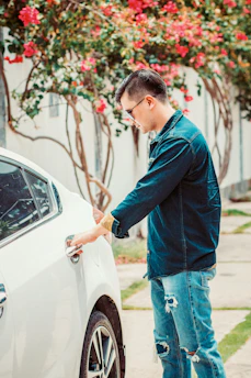 man opening white car door