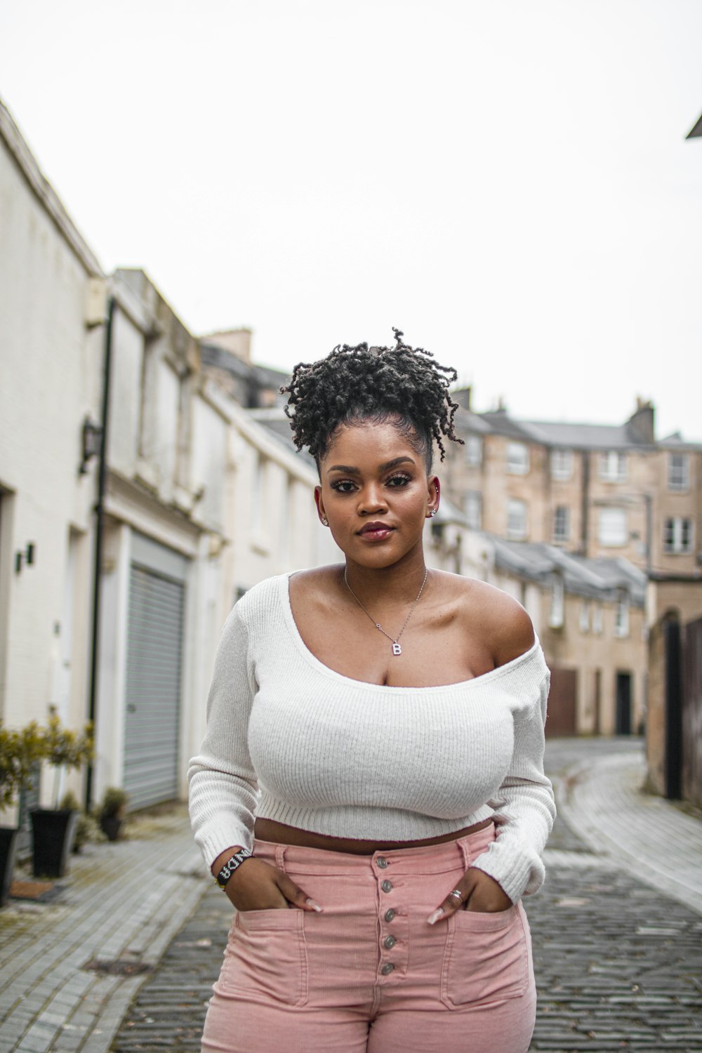 woman in white crop-top and pink bottoms