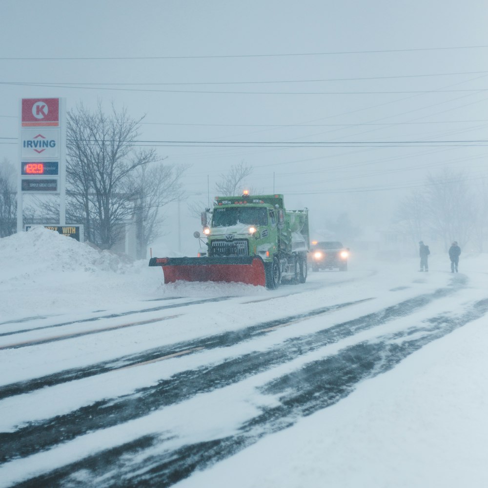 truck plowing snow on road