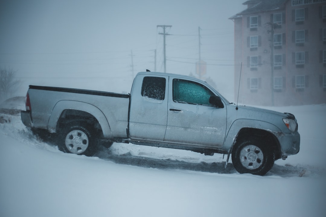 white extended cab pickup truck parked on hill