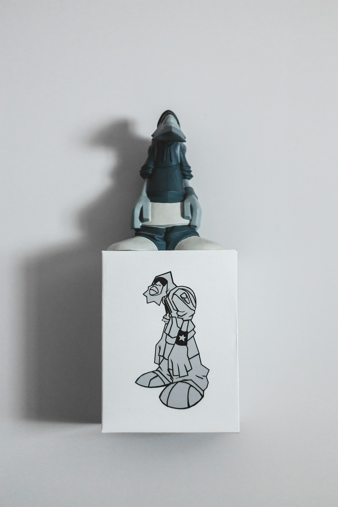 man figurine on box