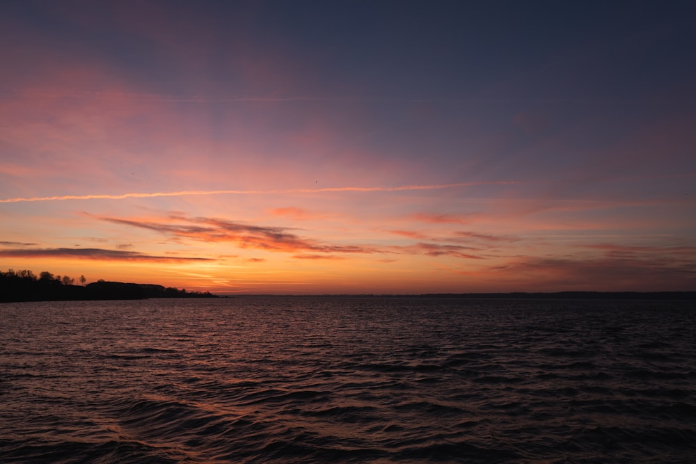 calm body of water during golden hour