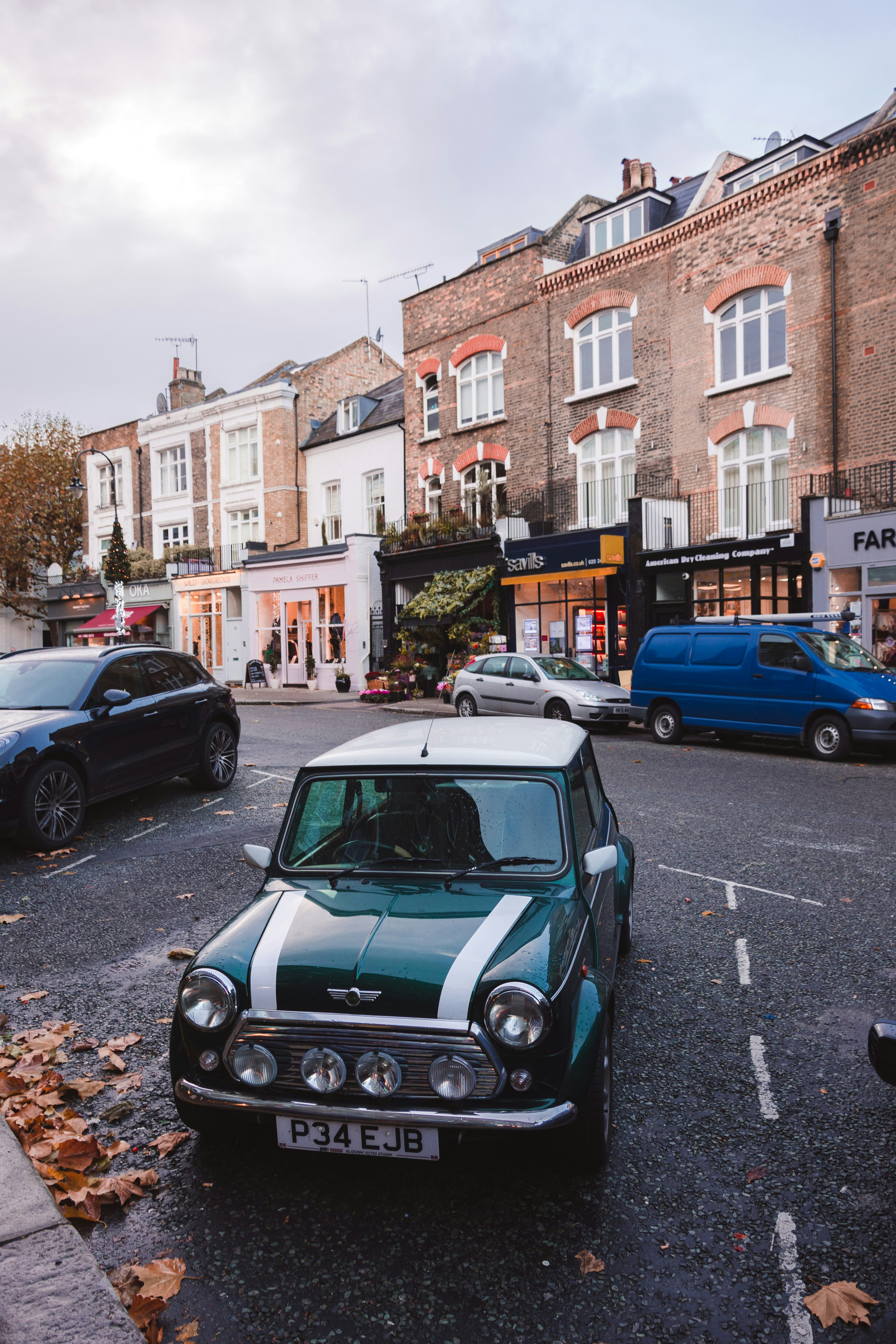 teal and white Mini Cooper parked on parking lot