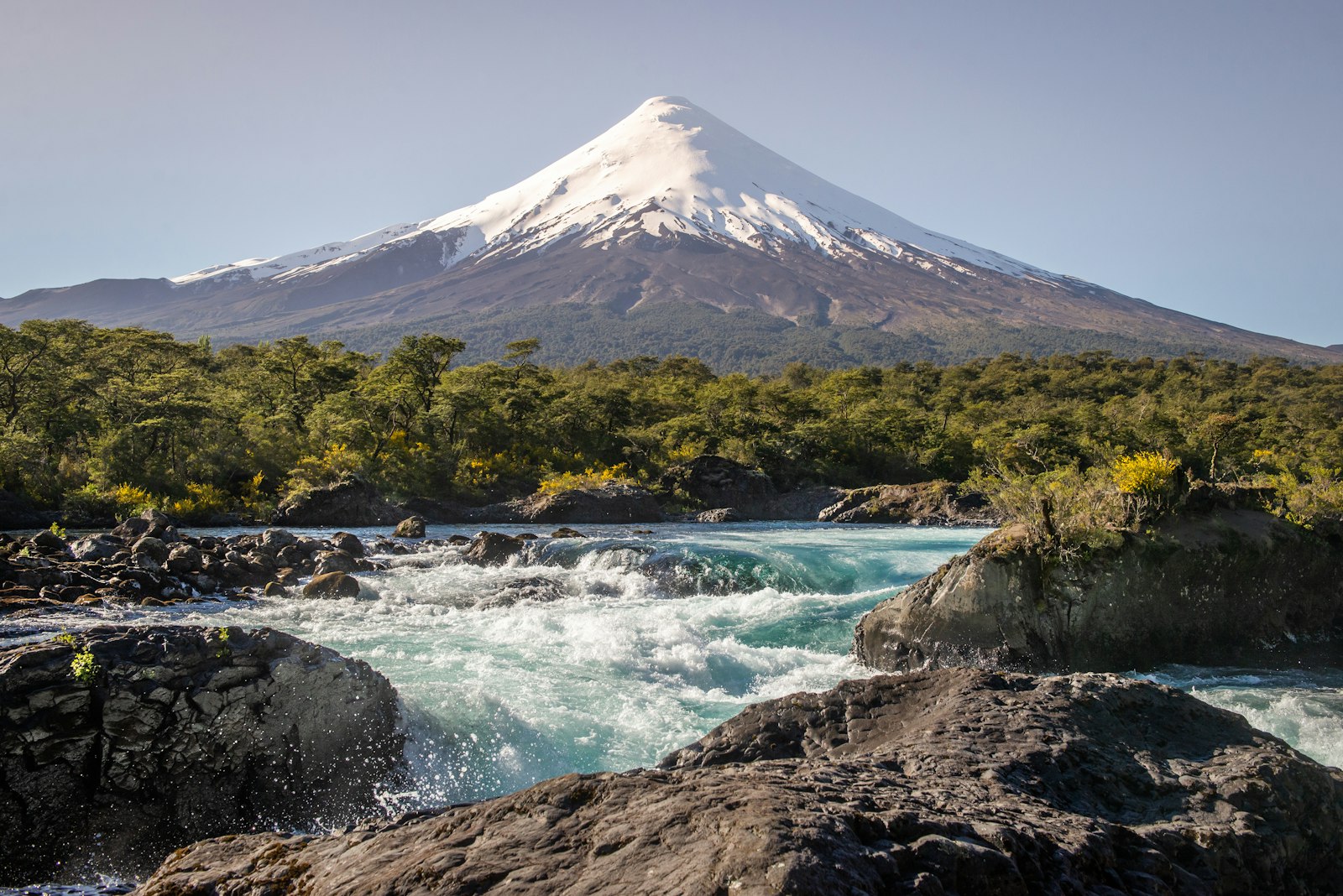 Osorno Volcano rising above the turquoise rapids of the Petrohué Falls