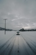 white vehicle on road covered with snow