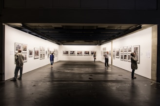 people standnig in front of paintings