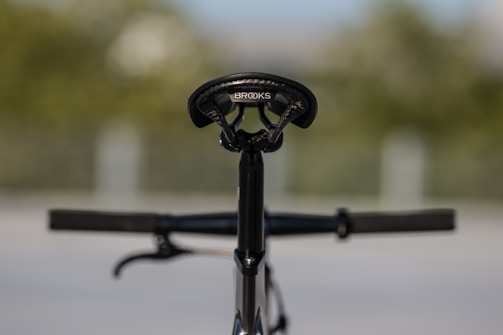 A selection of saddles displayed on a bike in an outdoor setting, ready for a test ride.