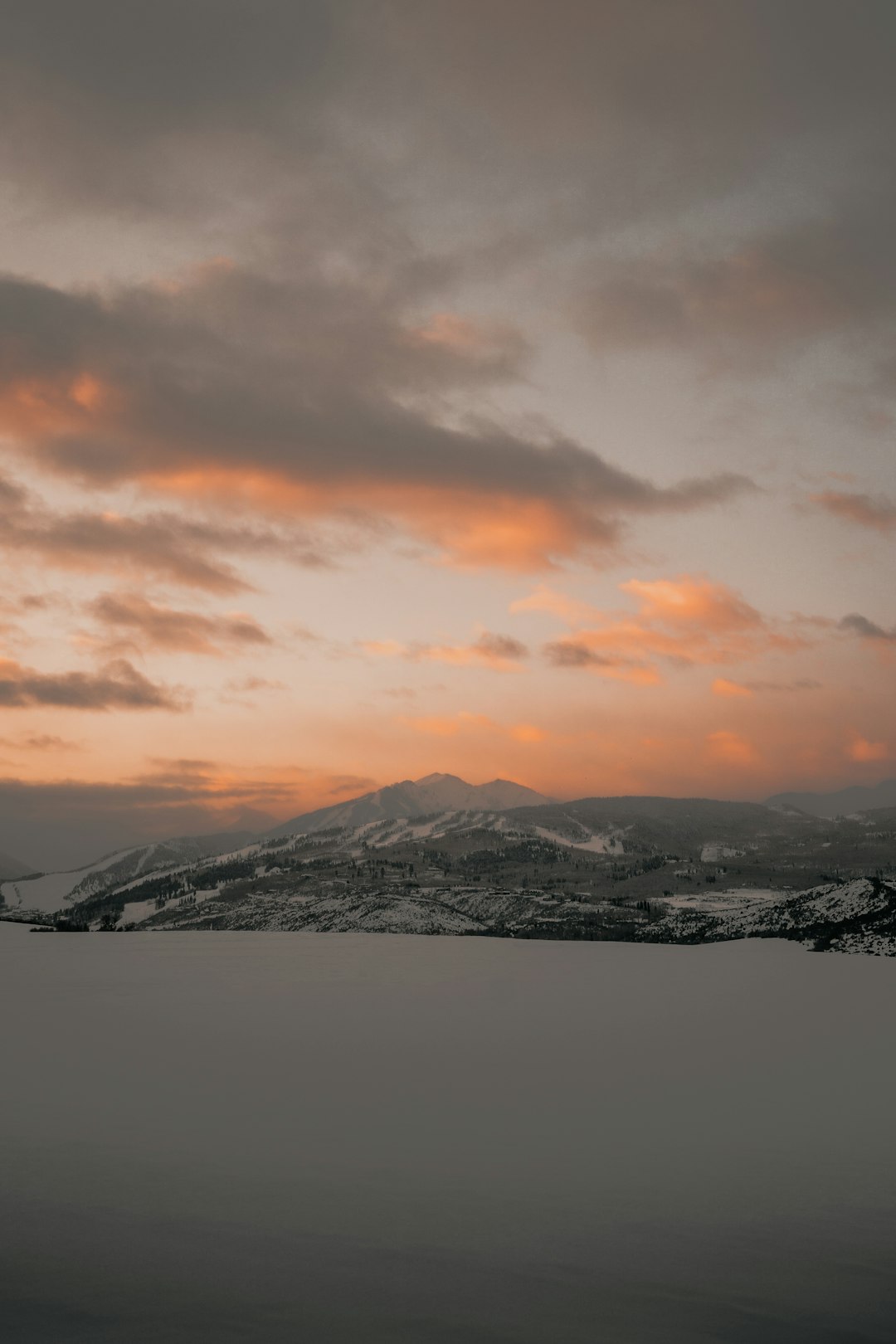 snow capped mountain under cloudy sky during golden hour