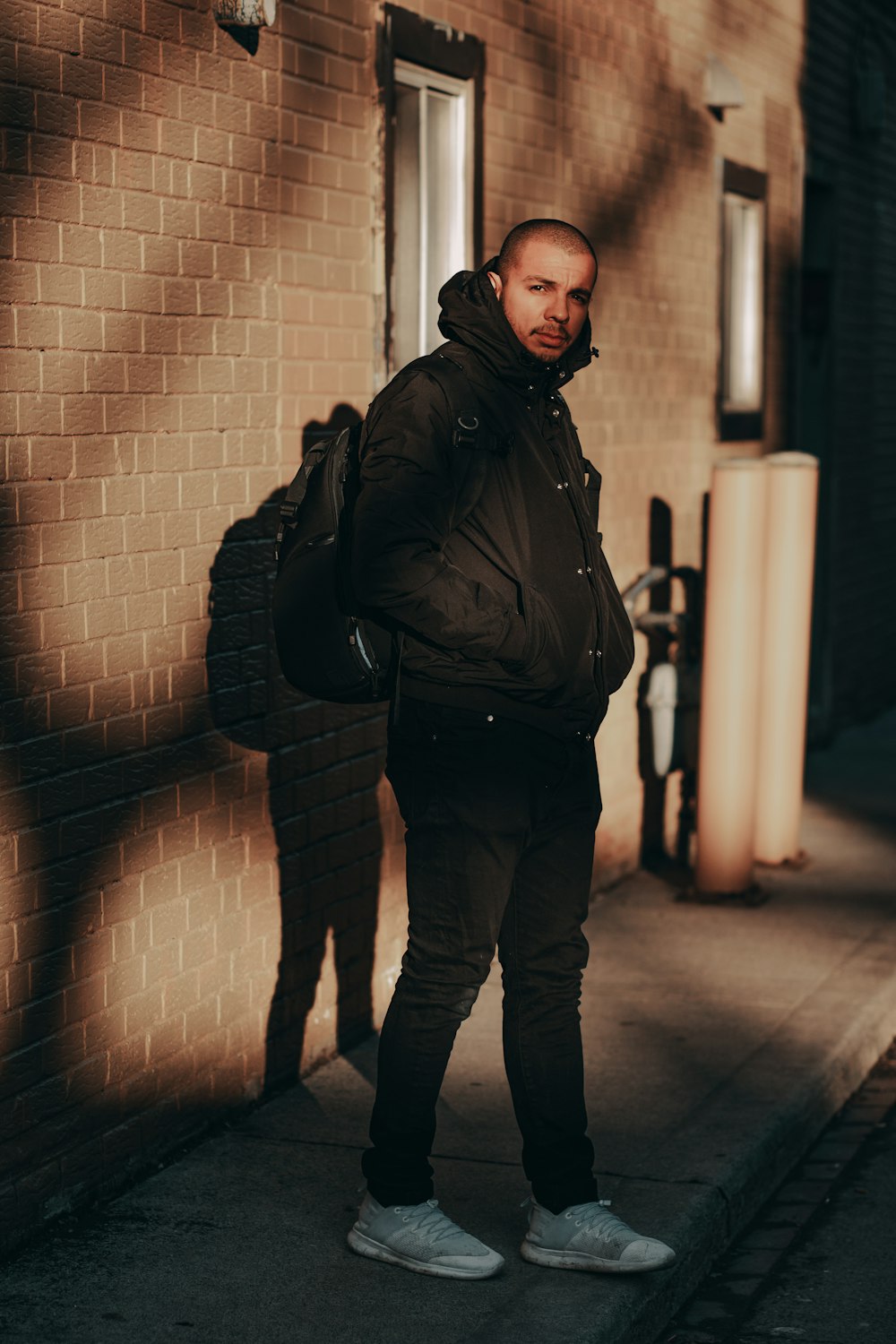 man standing beside building during daytime