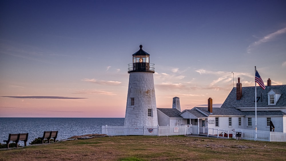 white and black concrete lighthouse during daytime