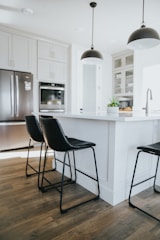 Designer pendant lights illuminating a contemporary kitchen island.