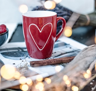 red ceramic mug on printing paper