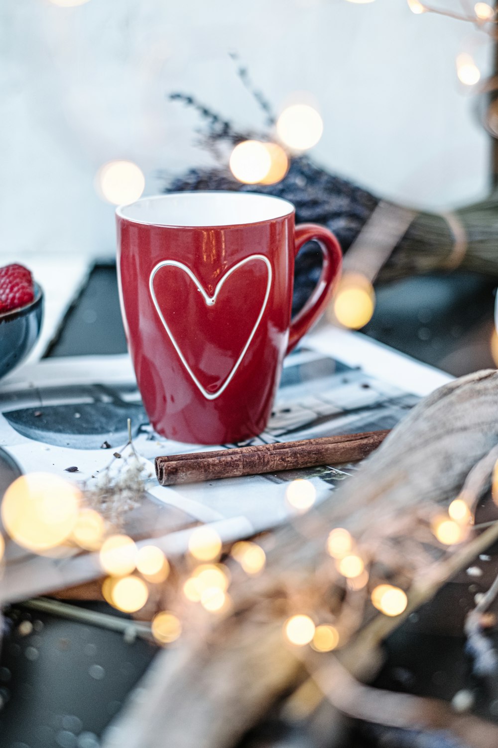 red ceramic mug on printing paper