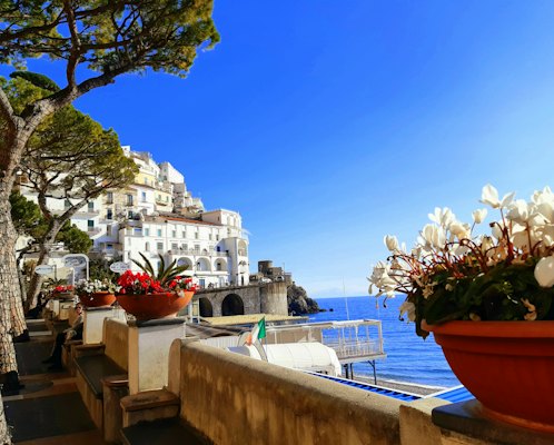 White concrete building near body of water during daytime — Amalfi Coast, Italy