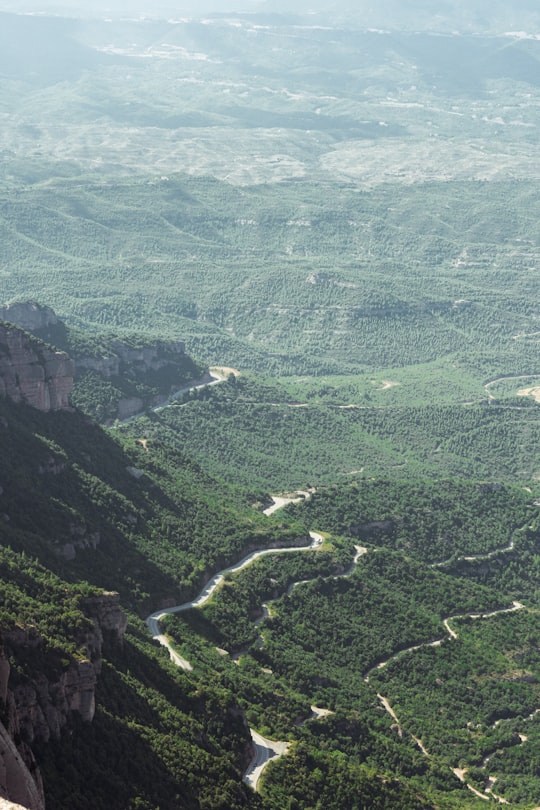 grass field and mountains during daytime in Montserrat Spain