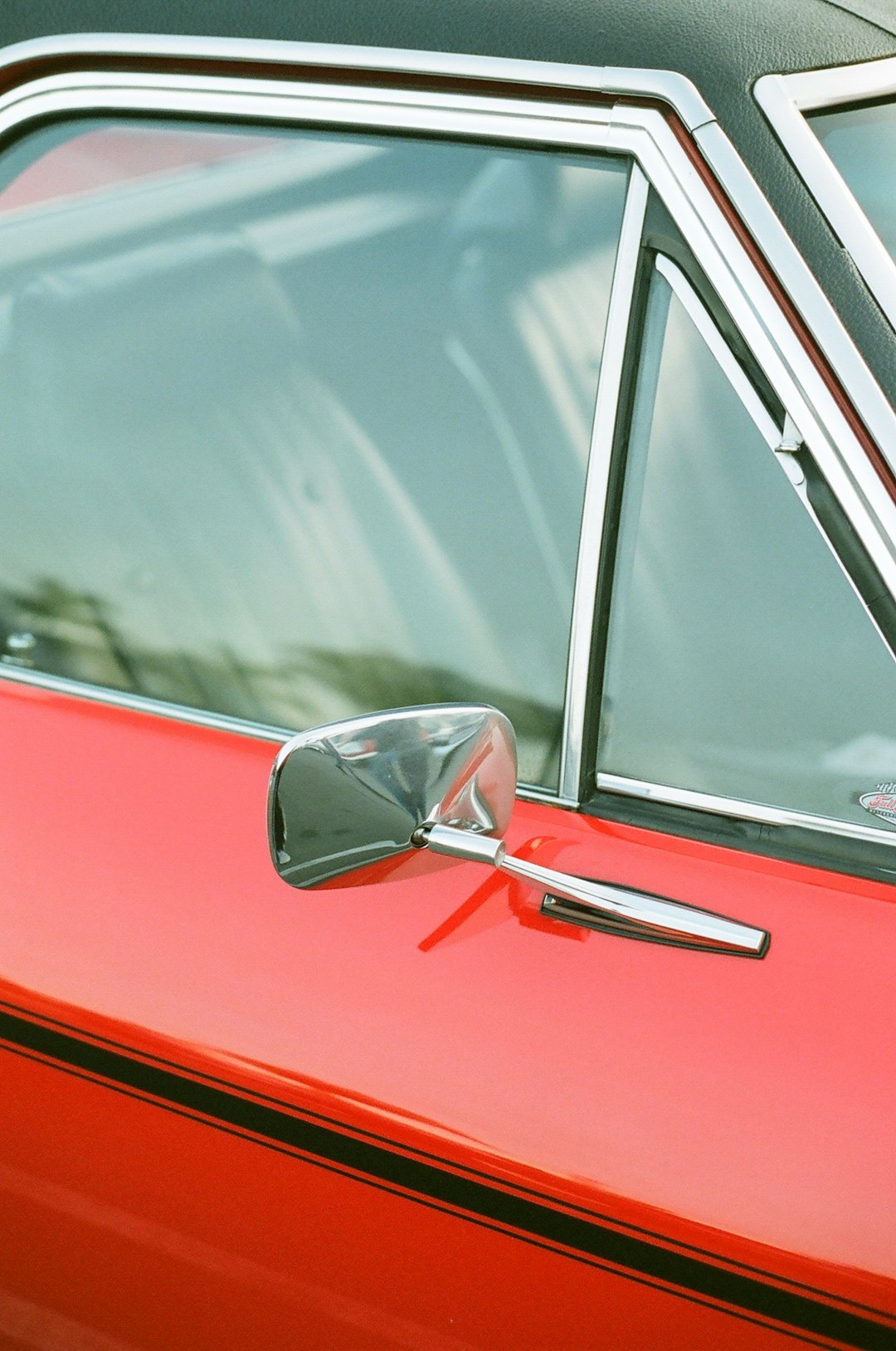 parked red and black car during daytime