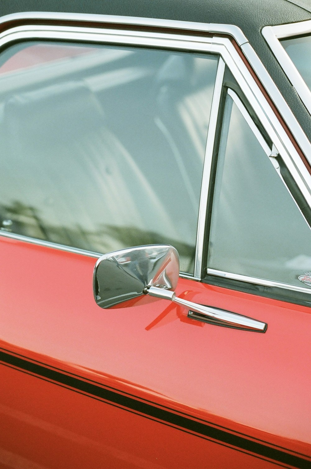 parked red and black car during daytime