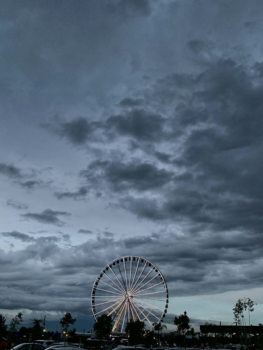 ferris wheel under cloudy sky during daytime