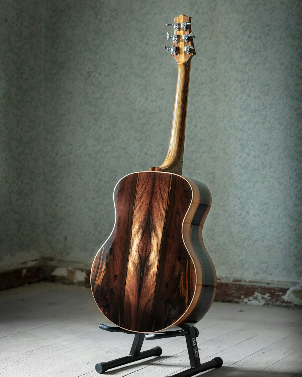 brown acoustic guitar on white textile