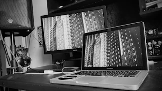 Dark-themed modern workspace with audio equipment and a sleek black background.
