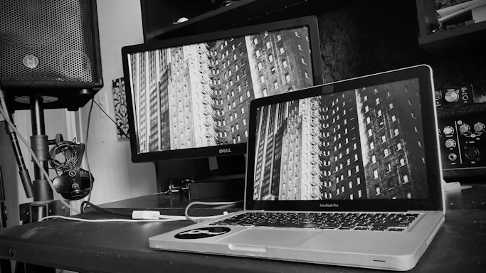 Dark-themed modern workspace with audio equipment and a sleek black background.