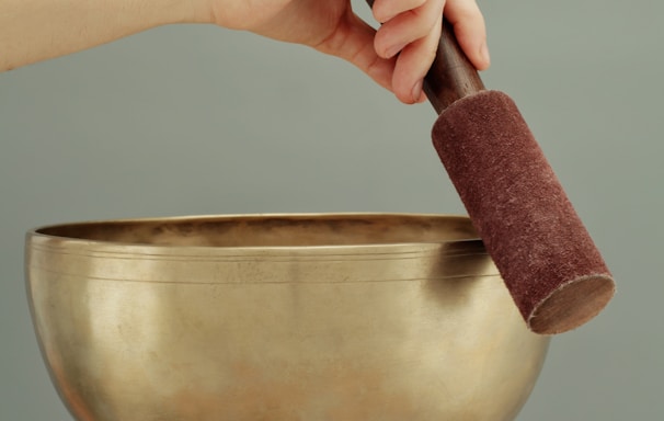 person holding brown clay pot