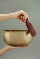 person holding brown clay pot