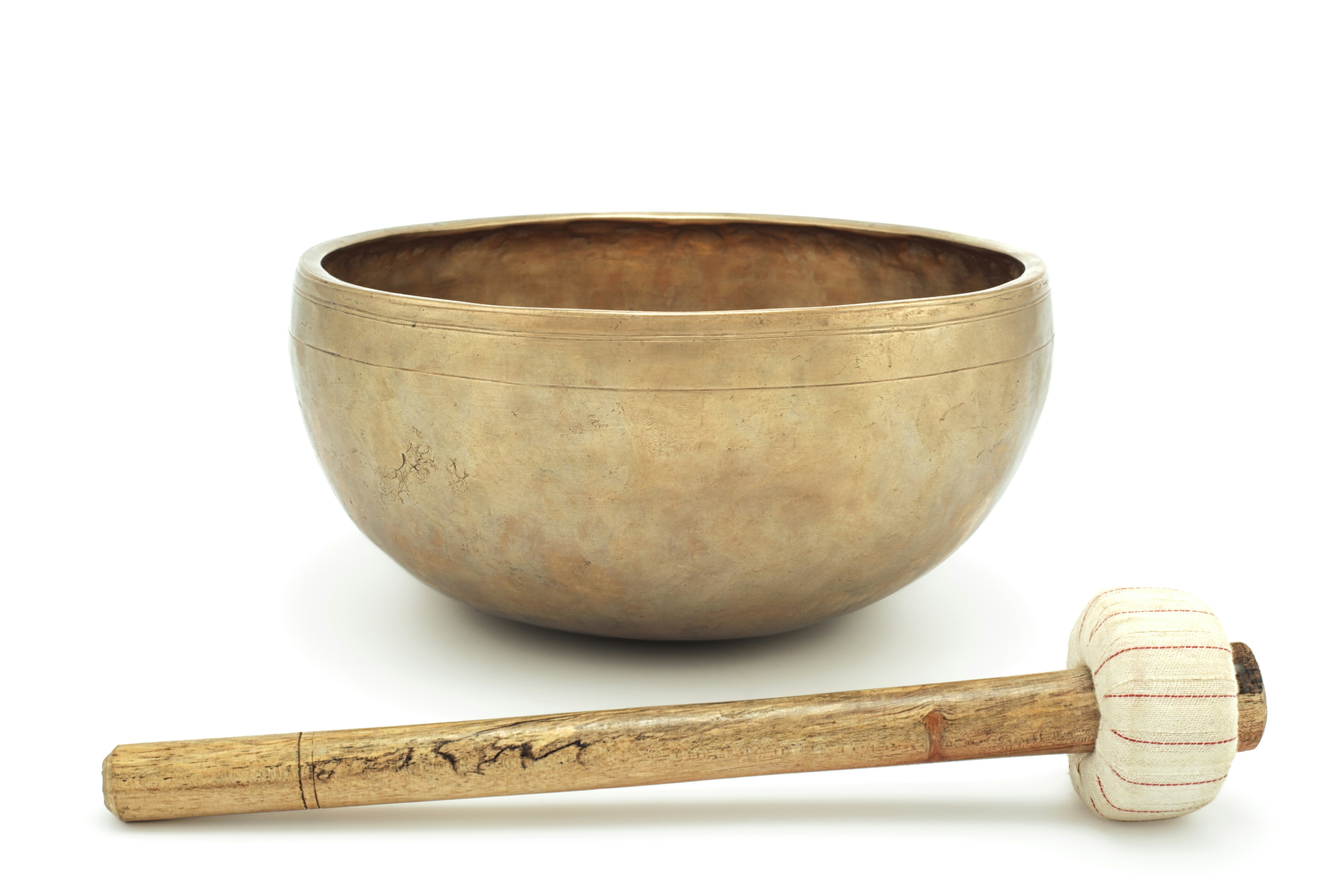 brown wooden spoon on brown ceramic bowl, Antique singing bowl  with a mallet. Singing bowls meditation 