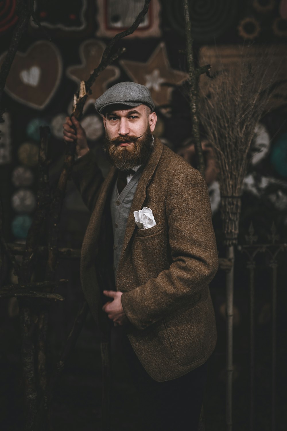 man in brown coat standing beside wall