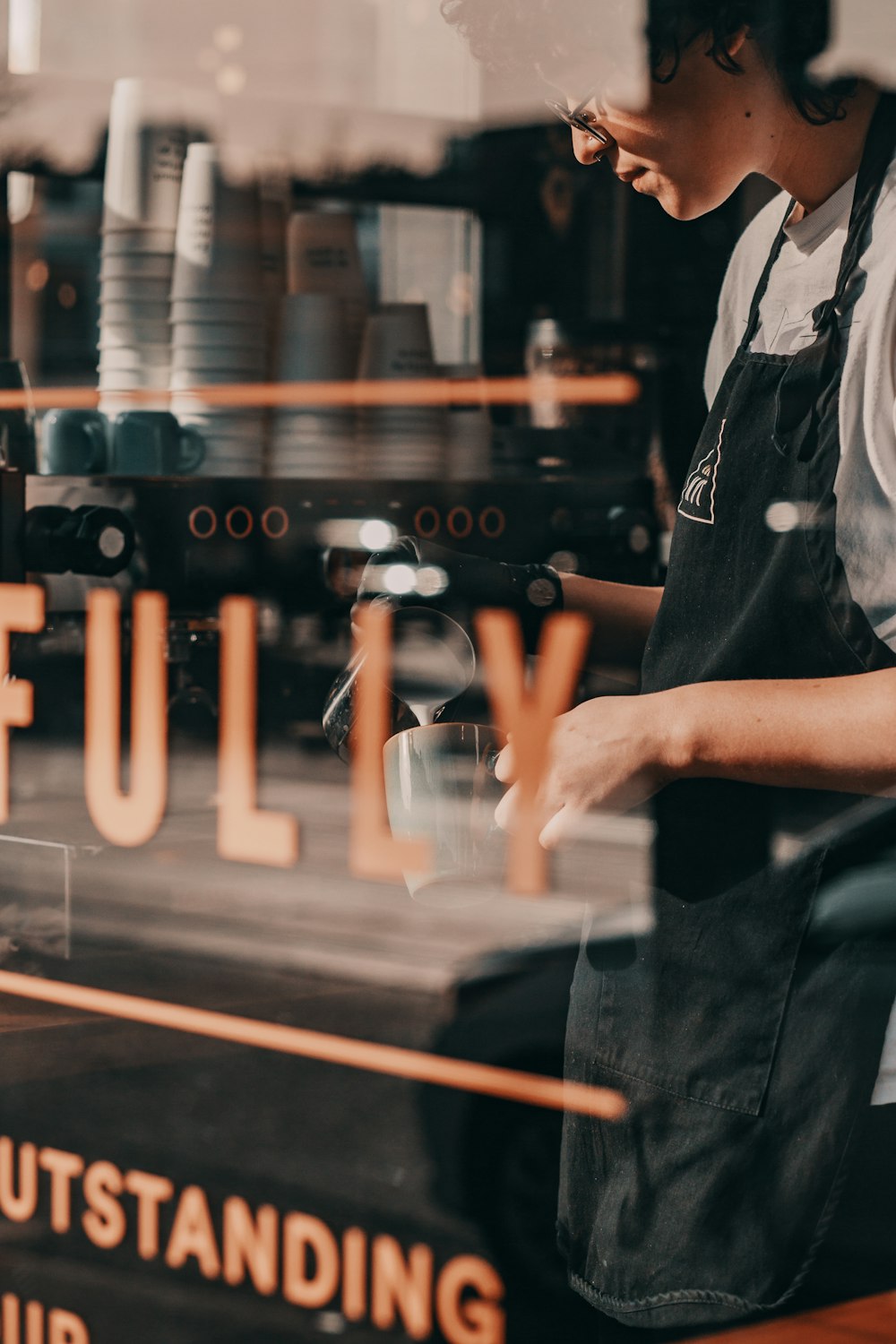 man wearing black apron