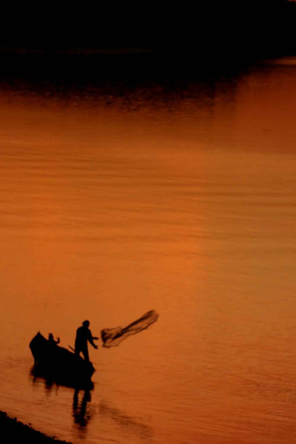 silhouette of man and woman on beach during sunset