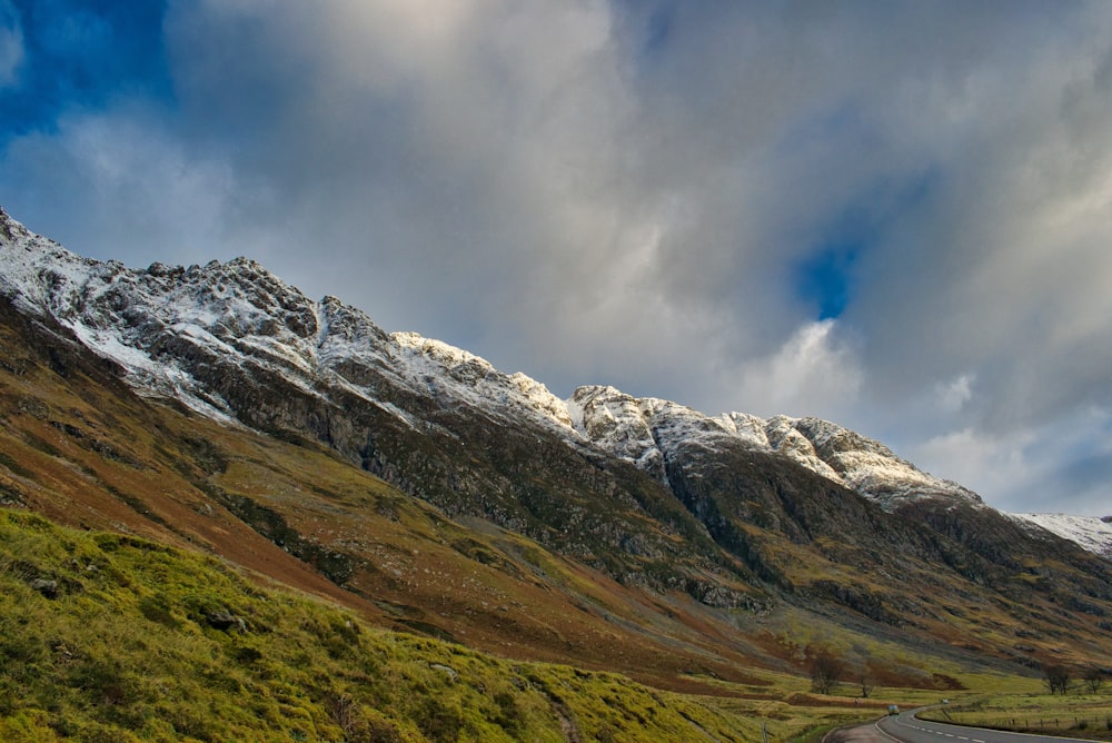 snow covered mountain under cloudy sky during daytime