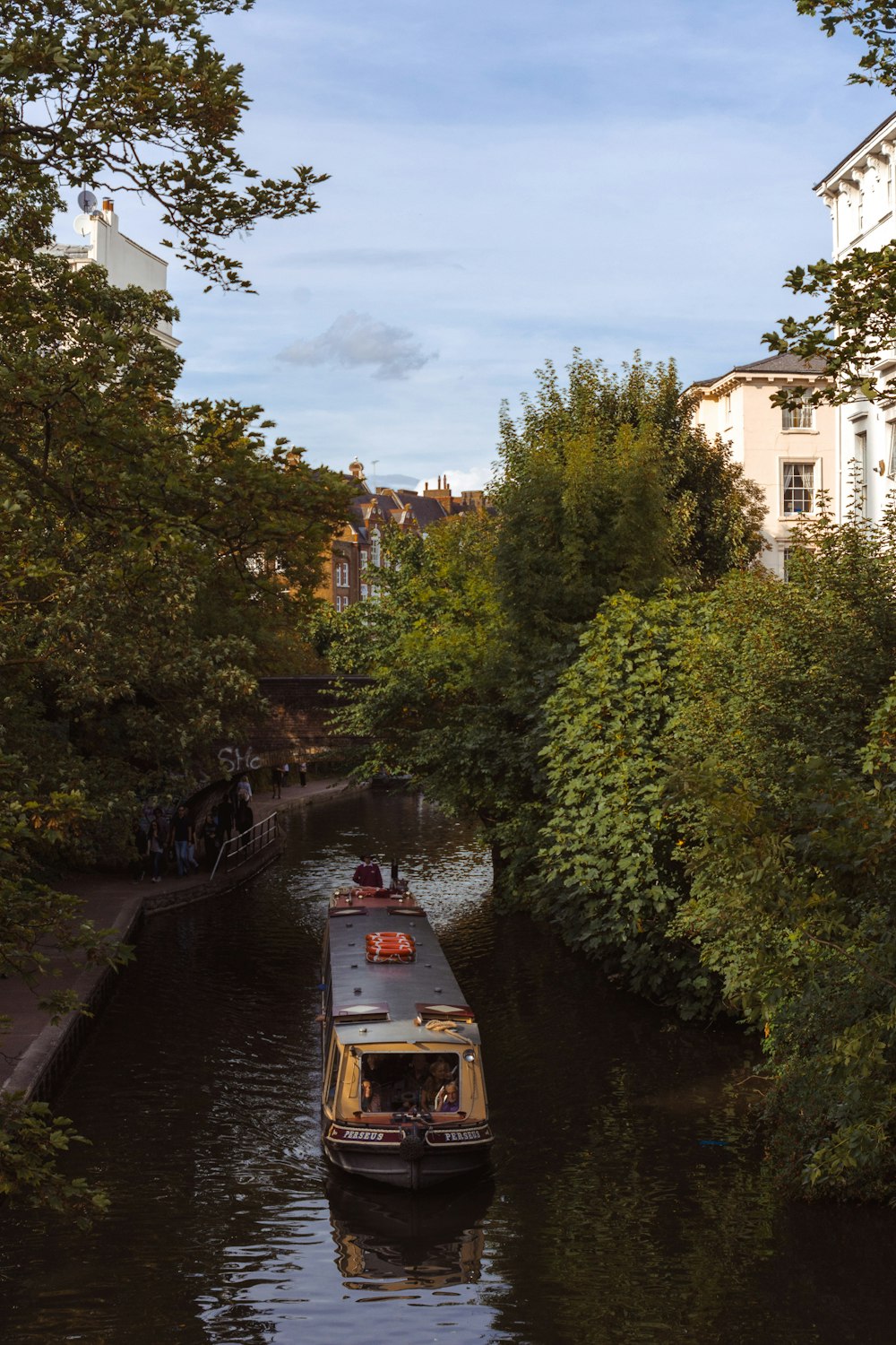 photography of traveling boat on river during daytime