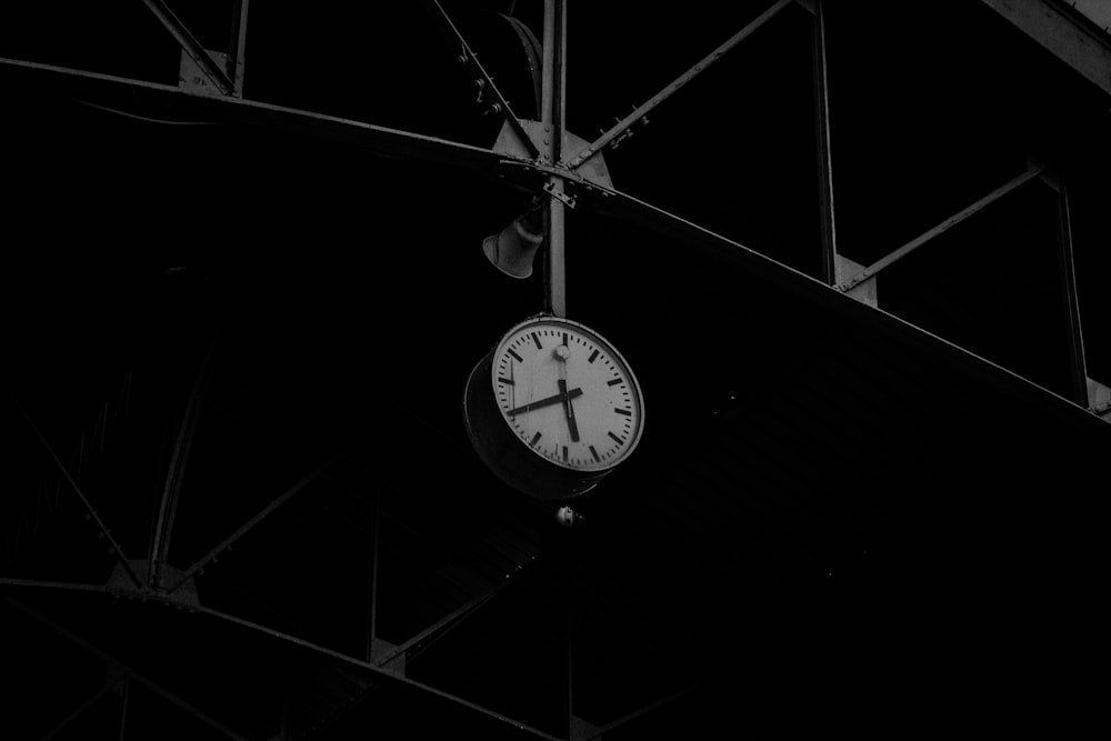 grayscale photo of round analog wall clock