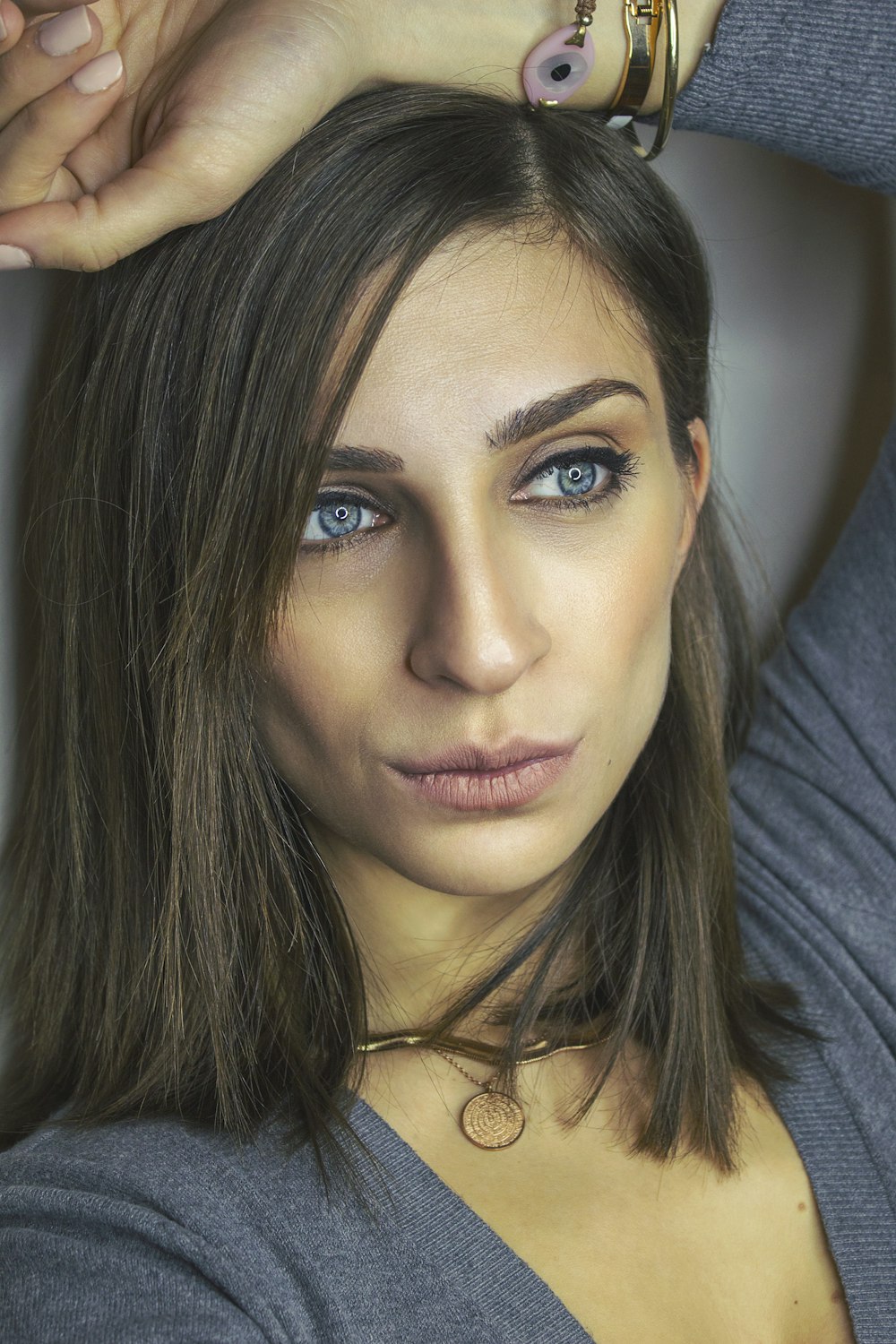 woman in blue long-sleeved top taking selfie