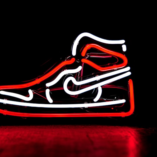 red and white Nike basketball shoe neon signage