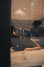 man and woman kissing beside table