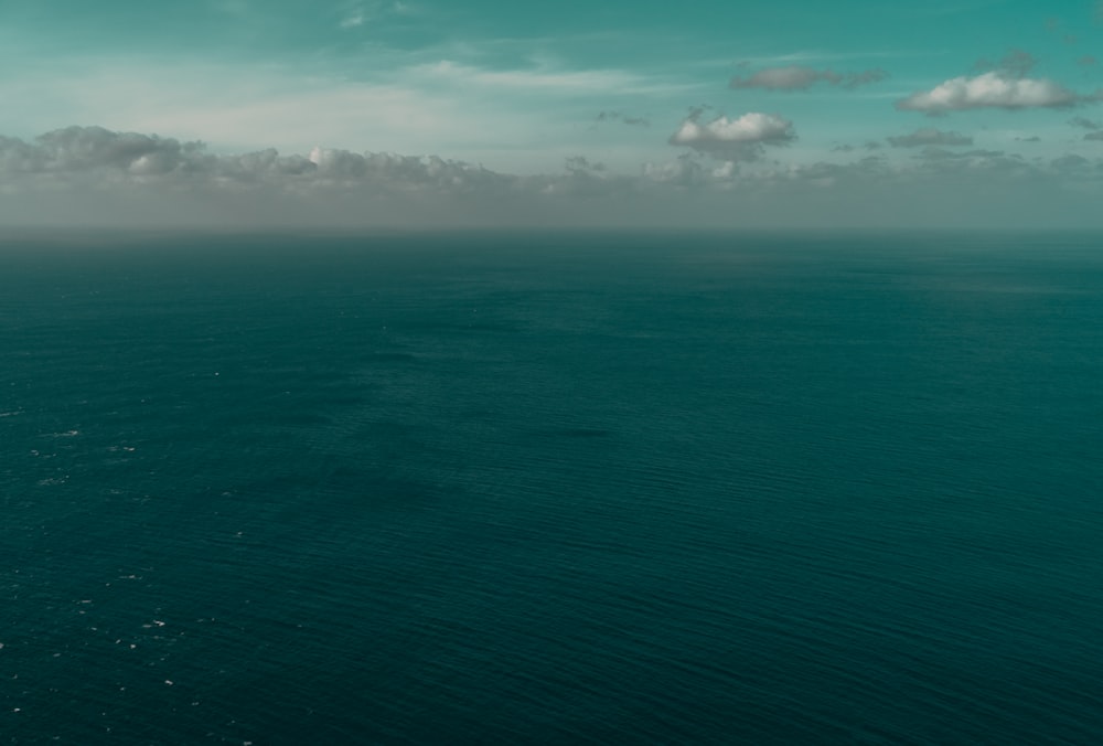 body of water under green sky