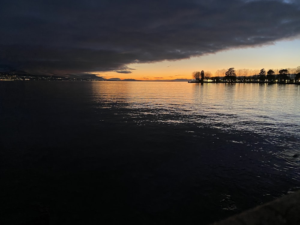 body of water during sunset