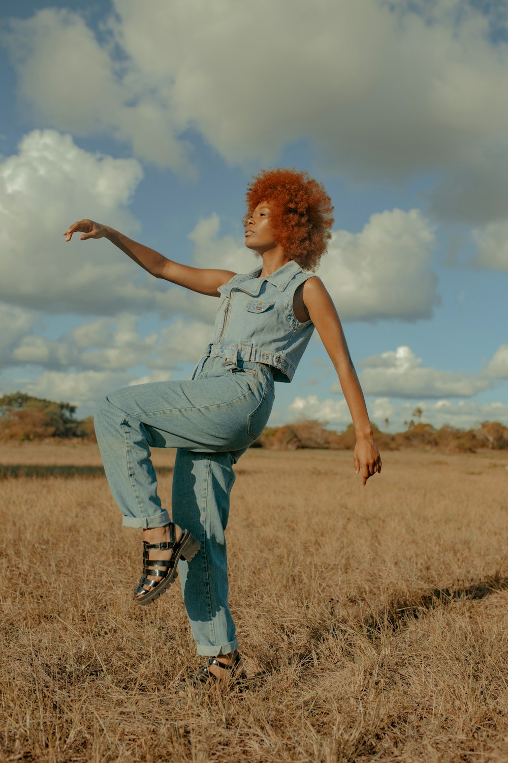 woman standing on brown field