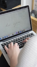 An inbox view showing a clean professional email with a handwritten digital signature at the bottom