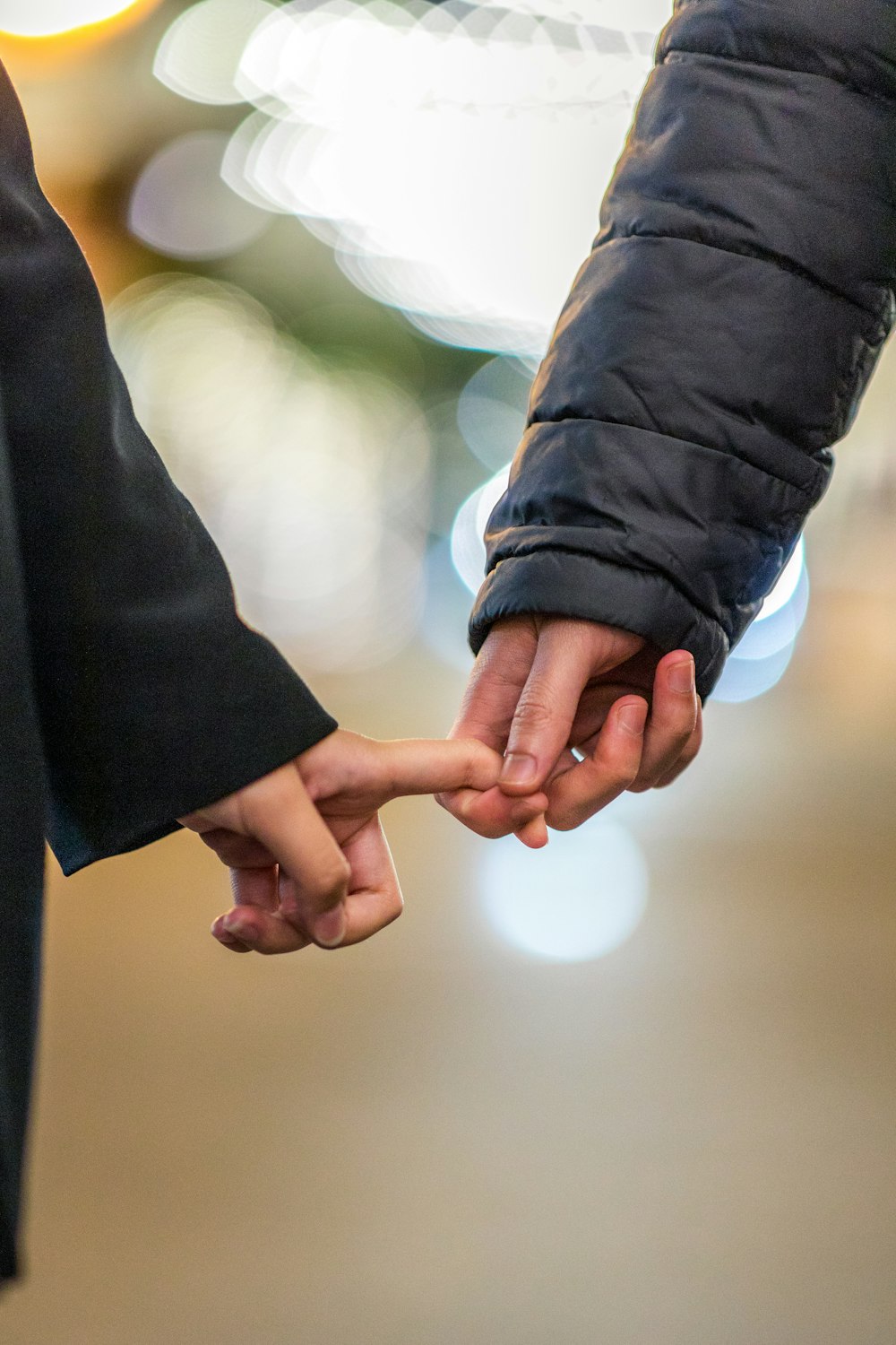 two people holding each others hands