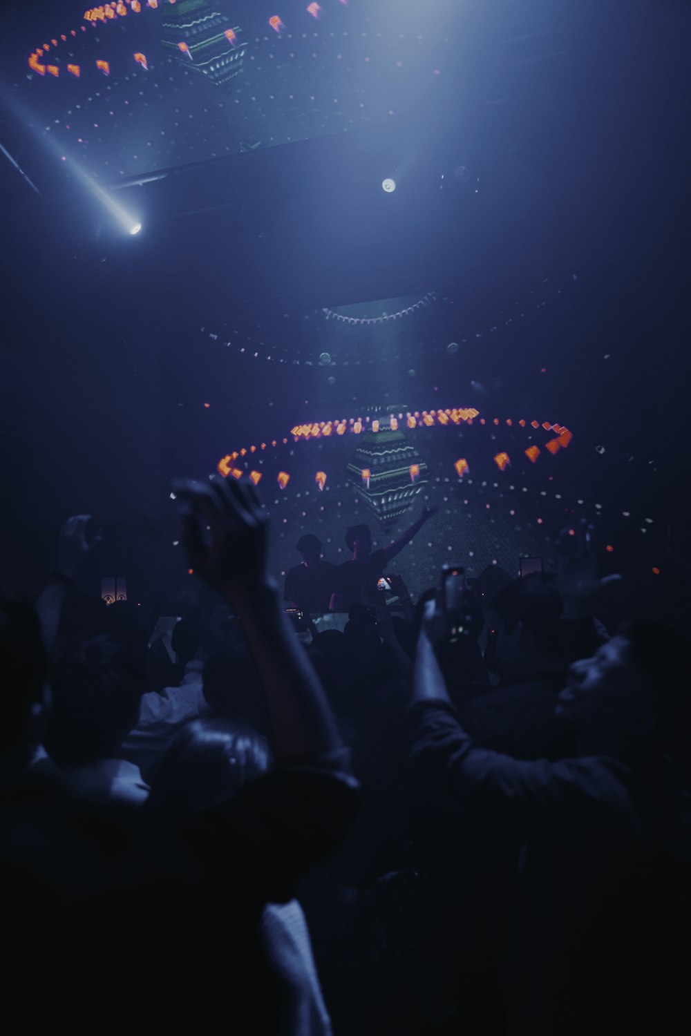 people standing on stage with lights