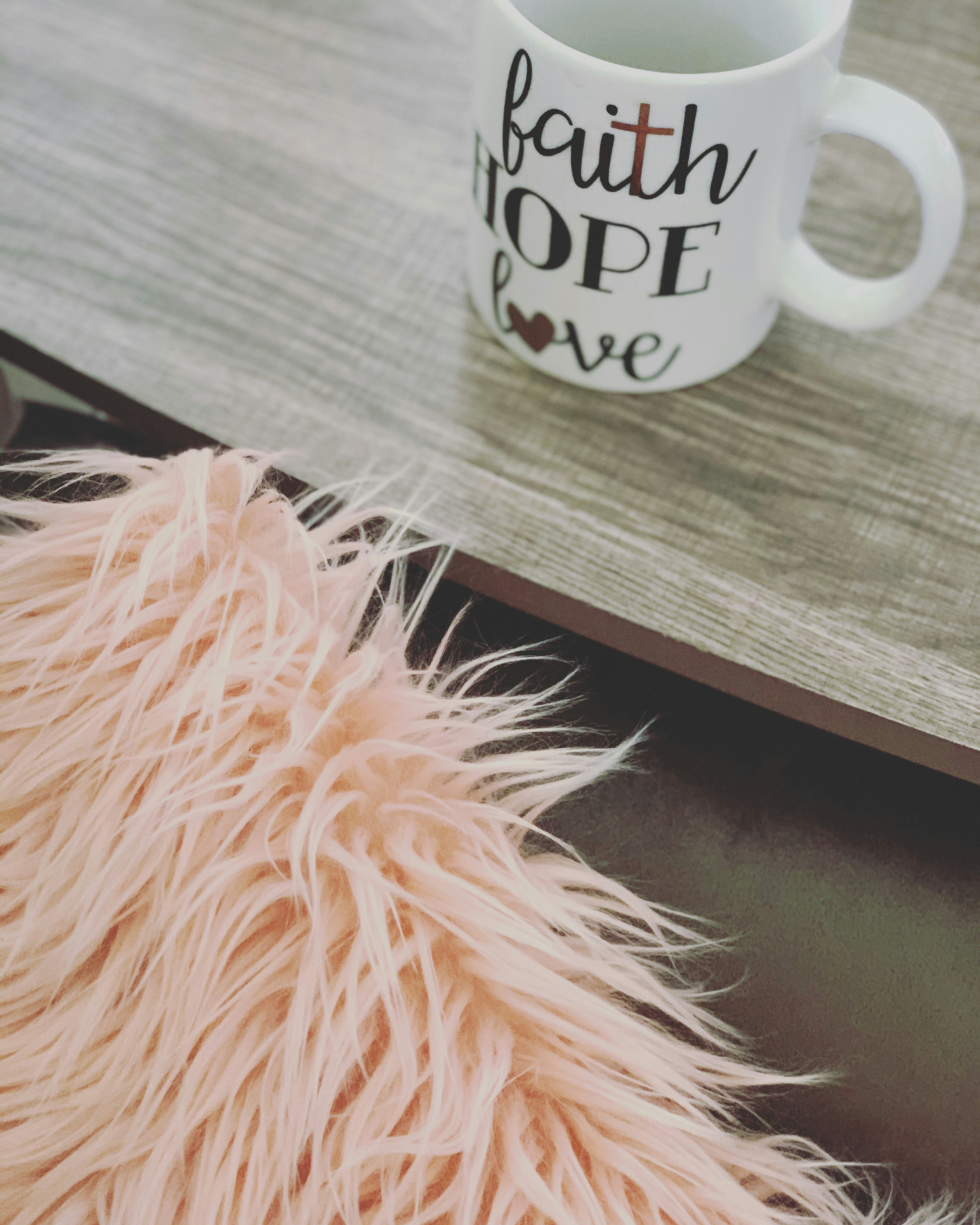 White ceramic mug with custom faith-based scripture print on warm lit surface
