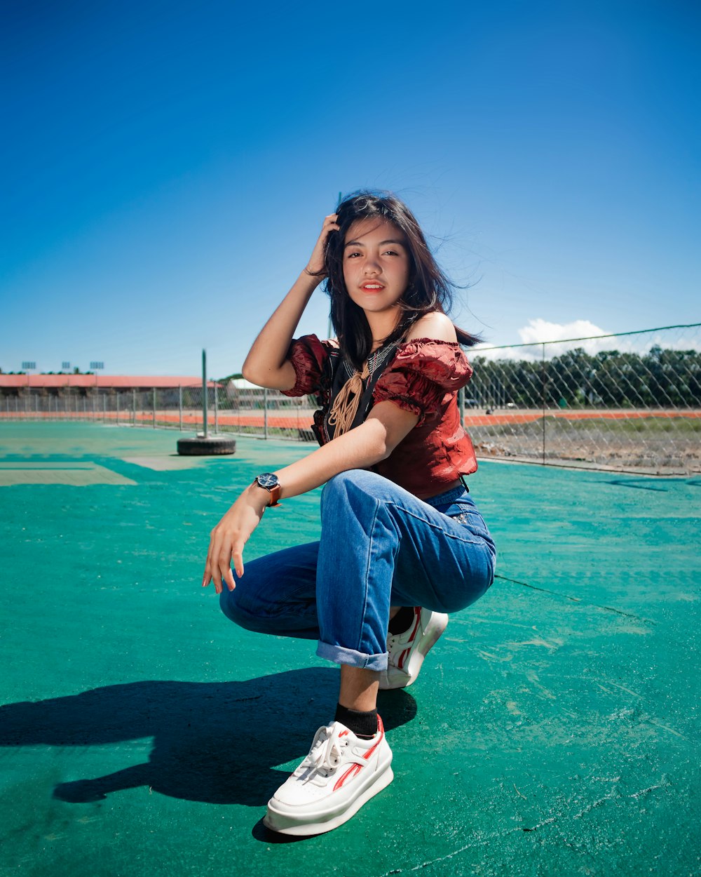 woman in blue denim jeans sitting on ground