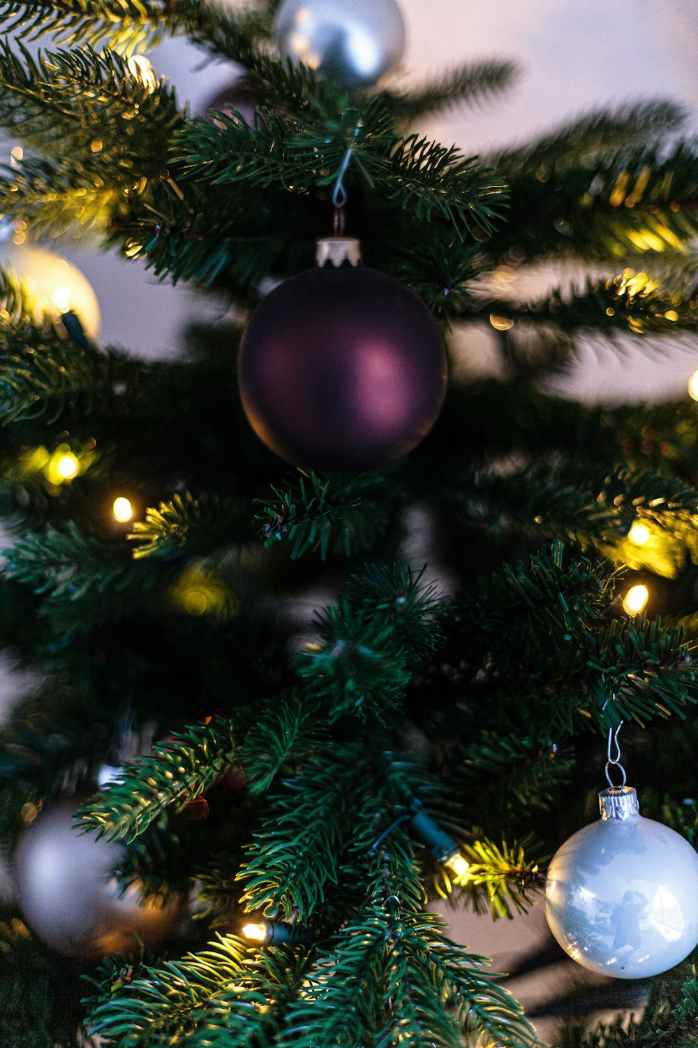 gold bauble on green christmas tree