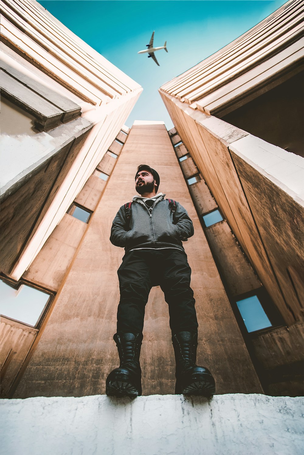 man standing beside buildings