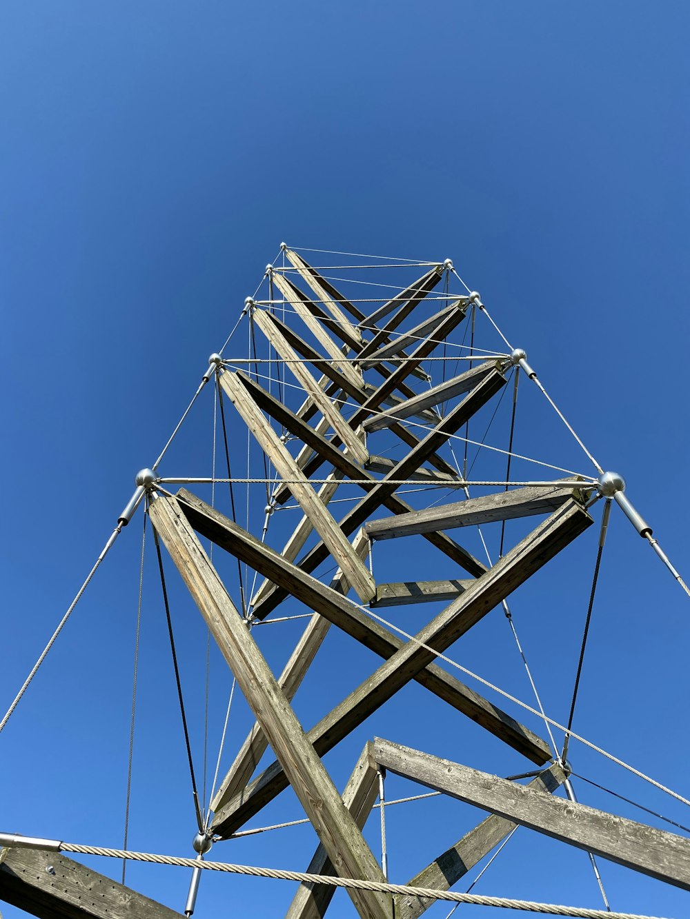 white metal electric post under blue sky during daytime